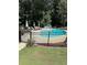 Backyard pool surrounded by a black metal fence and green landscaping, including a seating area at 4286 Pool Rd, Winston, GA 30187
