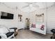 Relaxing sunroom features a swing, TV and a white paneled wall at 4286 Pool Rd, Winston, GA 30187