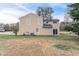 Side view of two-story home with siding and grassy backyard at 3045 Flat Shoals Rd, Atlanta, GA 30349