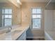 Bright bathroom features a large countertop, a tub with shower, and window at 3045 Flat Shoals Rd, Atlanta, GA 30349
