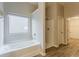 Bathroom with a soaking tub, separate shower, and wood-look flooring at 3045 Flat Shoals Rd, Atlanta, GA 30349