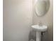Half bathroom with pedestal sink and oval mirror provides convenience for guests at 3045 Flat Shoals Rd, Atlanta, GA 30349