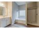 Modern bathroom featuring a vanity, soaking tub, and separate shower at 3045 Flat Shoals Rd, Atlanta, GA 30349
