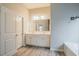 Bright bathroom featuring a double sink vanity, wood-look flooring, and neutral paint at 3045 Flat Shoals Rd, Atlanta, GA 30349