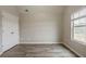 Empty bedroom featuring modern floors, closet space, and natural light through the window at 3045 Flat Shoals Rd, Atlanta, GA 30349