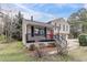 A cozy two-story home showcasing a charming front porch and a well-manicured lawn at 3045 Flat Shoals Rd, Atlanta, GA 30349