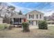 Charming two-story home featuring a cozy front porch and a classic red front door at 3045 Flat Shoals Rd, Atlanta, GA 30349