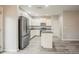 Open-concept kitchen with stainless appliances, granite counters, white cabinets, and gray floors at 3045 Flat Shoals Rd, Atlanta, GA 30349