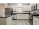 Modern kitchen with stainless steel appliances, granite countertops, and stylish gray flooring at 3045 Flat Shoals Rd, Atlanta, GA 30349