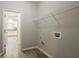 Laundry room with hookups, a storage shelf, and view to kitchen at 3045 Flat Shoals Rd, Atlanta, GA 30349