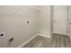 Laundry room with hookups, a storage shelf, and neutral walls at 3045 Flat Shoals Rd, Atlanta, GA 30349