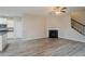 Spacious living room with a cozy fireplace and modern flooring open to the kitchen at 3045 Flat Shoals Rd, Atlanta, GA 30349