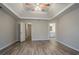 Large primary bedroom boasts tray ceiling, modern flooring, and ensuite bathroom at 3045 Flat Shoals Rd, Atlanta, GA 30349