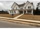 Two-story white brick home with covered porch and landscaped yard at 2505 Kirkwood Dr, Cumming, GA 30040