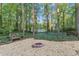 Fire pit area with gravel and lush greenery at 3630 Lake Se Dr, Smyrna, GA 30082