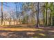 Large backyard with mature trees and open space at 1832 Vauxhall Dr, Lithonia, GA 30058