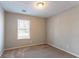 Simple bedroom with large window and neutral walls at 1832 Vauxhall Dr, Lithonia, GA 30058