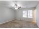 Primary bedroom with ceiling fan and large windows at 1832 Vauxhall Dr, Lithonia, GA 30058