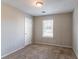 Well-lit bedroom featuring neutral walls and carpet at 1832 Vauxhall Dr, Lithonia, GA 30058