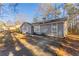 Newly renovated home with gray siding, and a long driveway leading to the front entrance at 1832 Vauxhall Dr, Lithonia, GA 30058