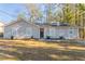 Newly renovated single-story home with gray siding, new landscaping, and a spacious yard at 1832 Vauxhall Dr, Lithonia, GA 30058