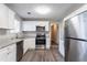 Renovated kitchen with white shaker cabinets, granite countertops, and stainless steel appliances at 1832 Vauxhall Dr, Lithonia, GA 30058