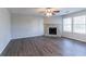 Living room featuring hardwood floors, a stone fireplace, and a ceiling fan at 1832 Vauxhall Dr, Lithonia, GA 30058
