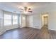 Open living room with wood-look flooring, ceiling fan, and access to hallway at 1832 Vauxhall Dr, Lithonia, GA 30058