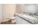Bathroom with granite countertop, white cabinets and a shower/tub combo at 4509 Central Dr, Stone Mountain, GA 30083