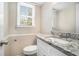 Clean bathroom with granite countertop, white vanity, and toilet at 4509 Central Dr, Stone Mountain, GA 30083