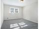 Bright bedroom with gray carpeting and a large window at 4509 Central Dr, Stone Mountain, GA 30083