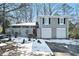 Gray two-story house with a two-car garage and a snow-covered front yard at 4509 Central Dr, Stone Mountain, GA 30083