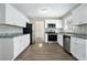 Modern kitchen with white cabinets, granite countertops and stainless steel appliances at 4509 Central Dr, Stone Mountain, GA 30083
