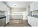 Modern kitchen with white cabinets, granite counters and stainless steel appliances at 4509 Central Dr, Stone Mountain, GA 30083