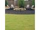 Backyard fire pit with seating and landscaping at 1999 Gladys Ct, Marietta, GA 30064