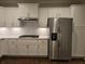 Modern kitchen featuring white cabinets, stainless steel appliances, and quartz countertops at 1999 Gladys Ct, Marietta, GA 30064