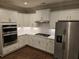 Modern kitchen with white cabinets, stainless steel appliances, and a quartz countertop at 1999 Gladys Ct, Marietta, GA 30064