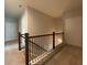 Upstairs hallway with wooden railing and carpet at 1999 Gladys Ct, Marietta, GA 30064