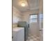 Well-lit laundry room features a stacked washer and dryer and built in shelving at 1999 Riverlanding Cir, Lawrenceville, GA 30046