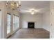 Spacious living room featuring a fireplace, ceiling fan, and lots of natural light at 1999 Riverlanding Cir, Lawrenceville, GA 30046