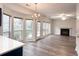 Open-concept living area with large windows, fireplace, and seamless flow to the kitchen at 1999 Riverlanding Cir, Lawrenceville, GA 30046