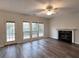 Cozy living room with a gas fireplace, ceiling fan, and access to the backyard at 1999 Riverlanding Cir, Lawrenceville, GA 30046