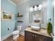 Light and airy powder room with stylish vanity and patterned wallpaper at 925 Upper Hembree Rd, Roswell, GA 30076