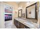 Jack and Jill bathroom with granite double vanity and patterned floor at 925 Upper Hembree Rd, Roswell, GA 30076