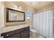 Bathroom with granite countertop, shower/tub combo, and white vanity at 925 Upper Hembree Rd, Roswell, GA 30076