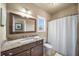 Bathroom with granite countertop, shower/tub combo, and white vanity at 925 Upper Hembree Rd, Roswell, GA 30076