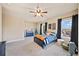 Bright bedroom featuring two windows, ceiling fan, and navy blue accents at 925 Upper Hembree Rd, Roswell, GA 30076