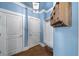 Laundry room with built-in bench, hooks, and blue walls at 925 Upper Hembree Rd, Roswell, GA 30076