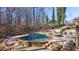 Large kidney-shaped pool with surrounding patio at 925 Upper Hembree Rd, Roswell, GA 30076