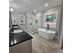 Modern bathroom featuring a soaking tub, glass-enclosed shower, and dual sink vanity at 6093 Wayfarer Dr, Villa Rica, GA 30180